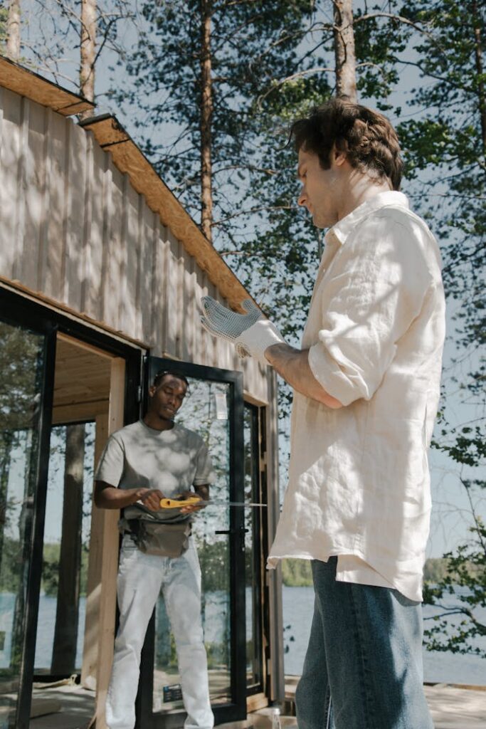 Men Building a Wooden Cabin in a Forest